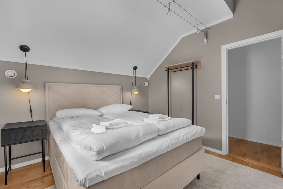 Chic bedroom with large double bed and cozy lighting