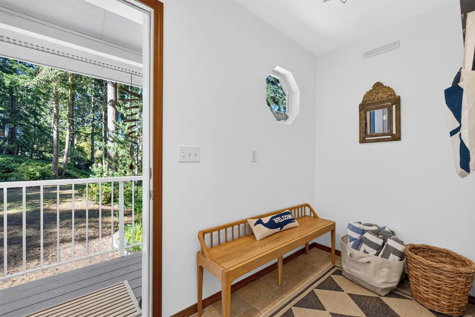 Cozy mudroom alcove or entry bench area adjacent to the outdoor deck access.