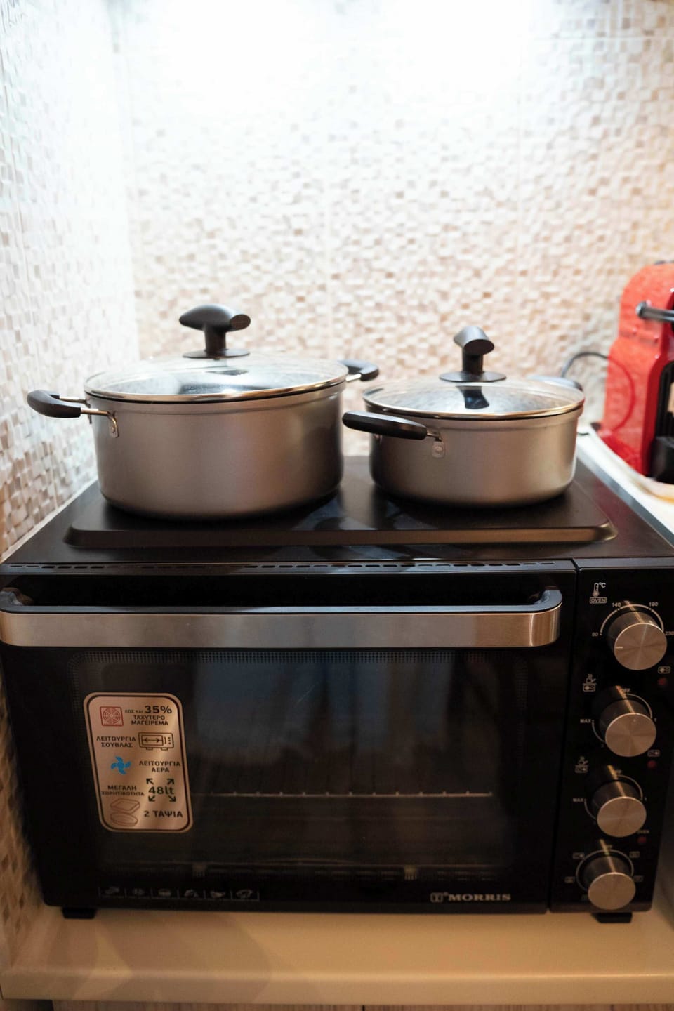 Kitchen stove and cookware, ideal for preparing simple meals during your stay