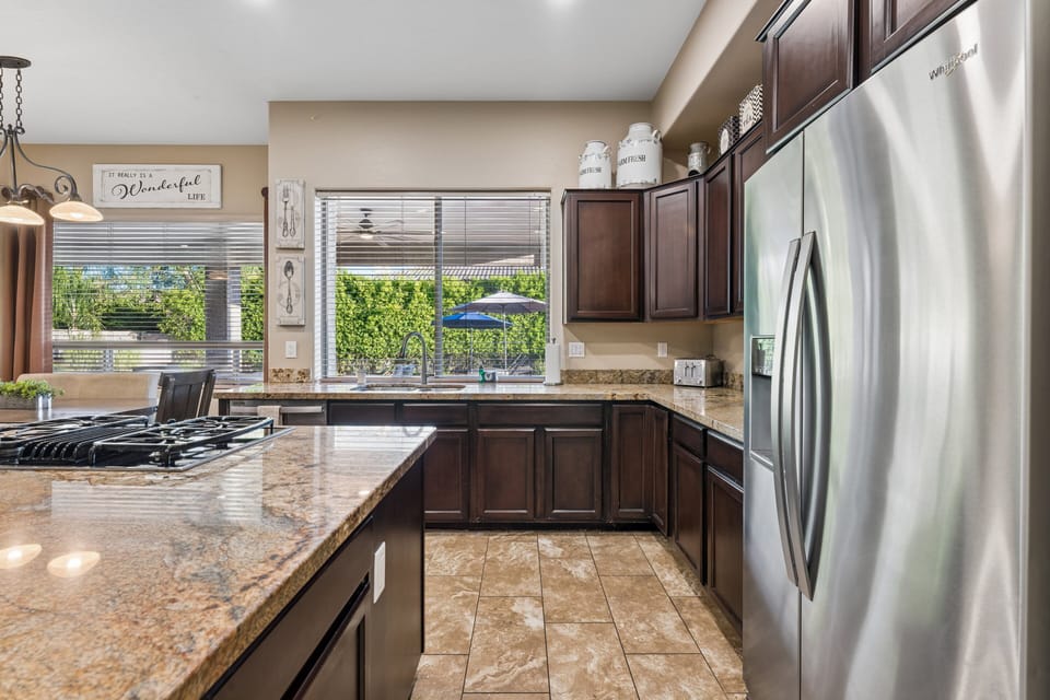 Chef's kitchen with large island, plenty of counter space, and stainless steel appliances.