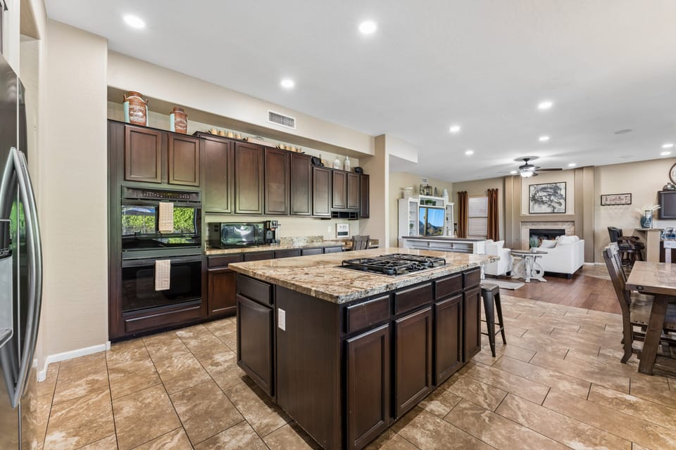 Chef's kitchen with large island, plenty of counter space, and stainless steel appliances.