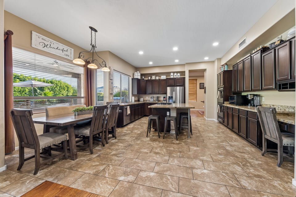 Dining area with a table and seating for can be seen just off of the living room and kitchen.