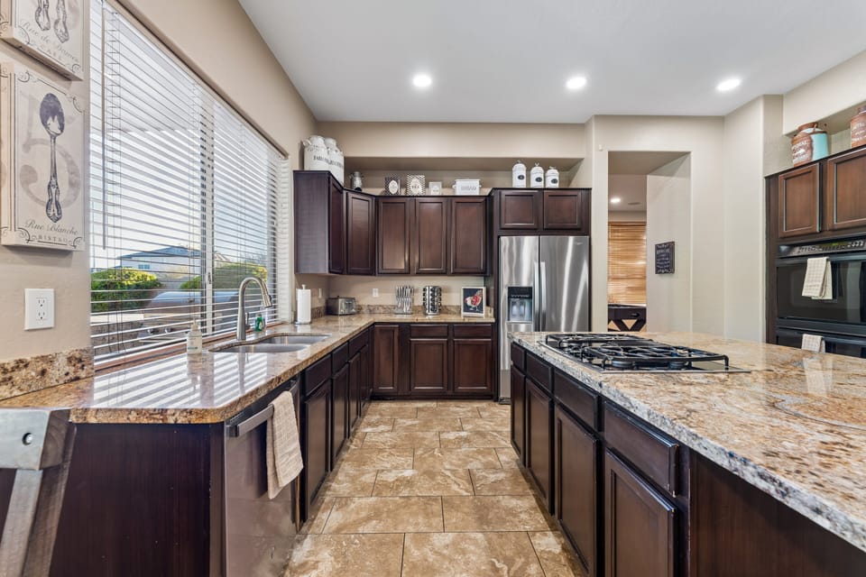 Chef's kitchen with large island, plenty of counter space, and stainless steel appliances.