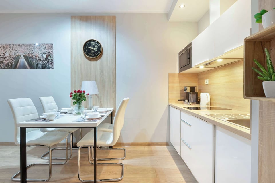 Functional kitchenette with modern appliances, storage space, and a practical layout for preparing light meals.