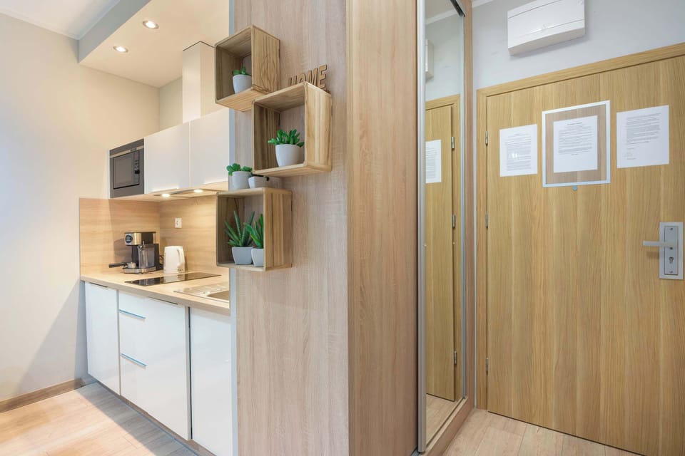 Functional kitchenette with modern appliances, storage space, and a practical layout for preparing light meals.
