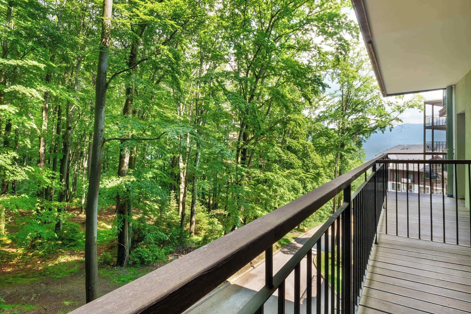 Private balcony surrounded by greenery, offering a peaceful setting to relax and enjoy nature views.