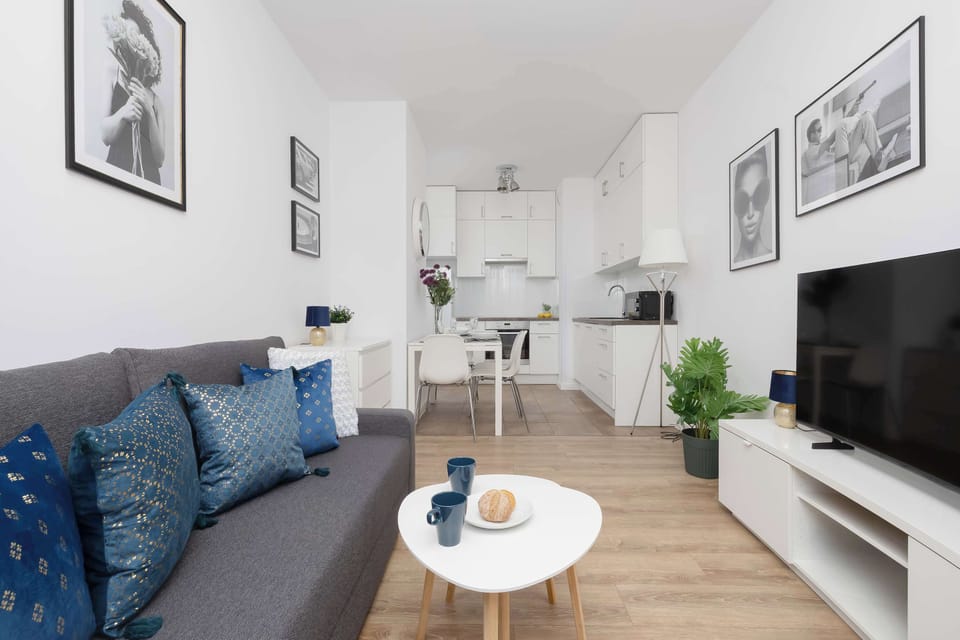 Modern open-plan living room with kitchenette and dining space.