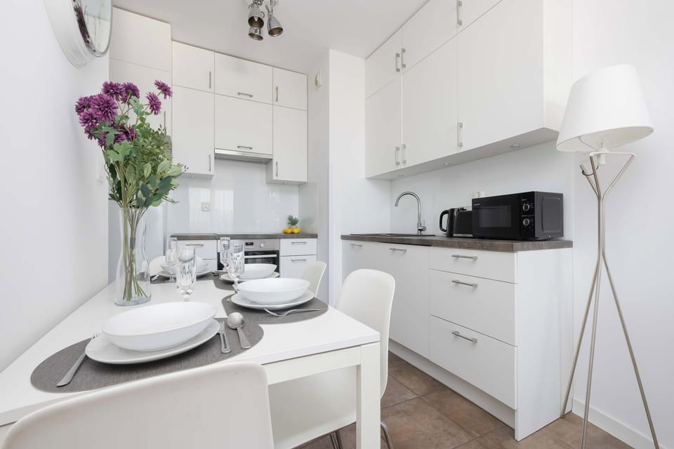 Modern kitchenette with essential appliances and ample storage.