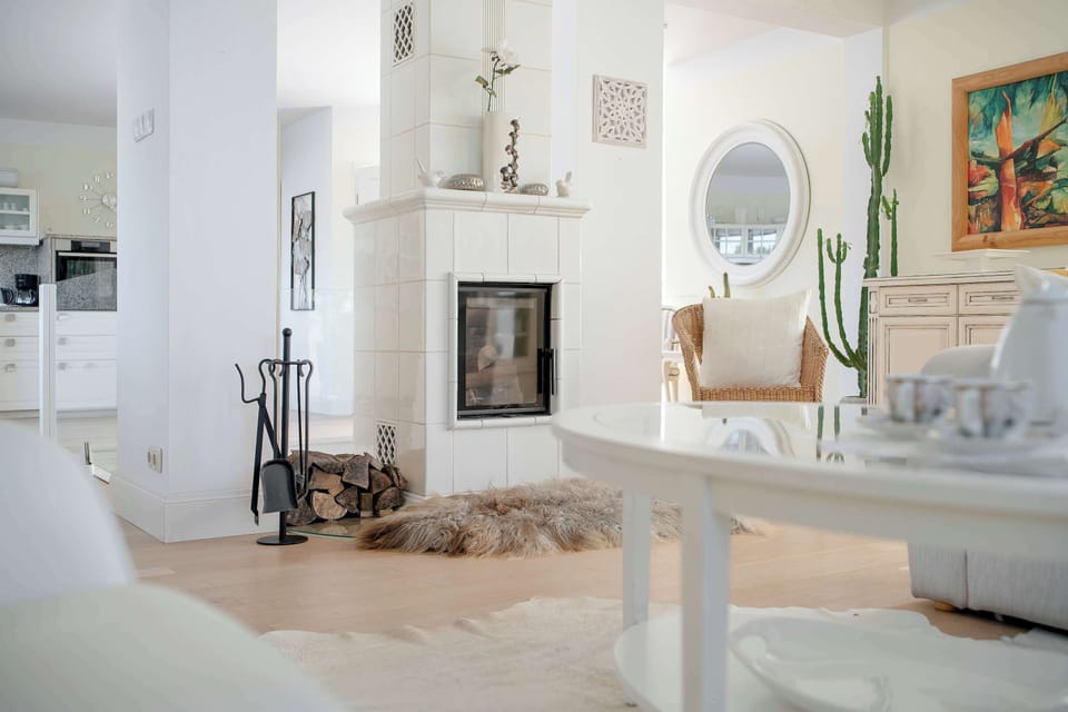 Stylish view of the living room showcasing the fireplace and elegant interior finishes.