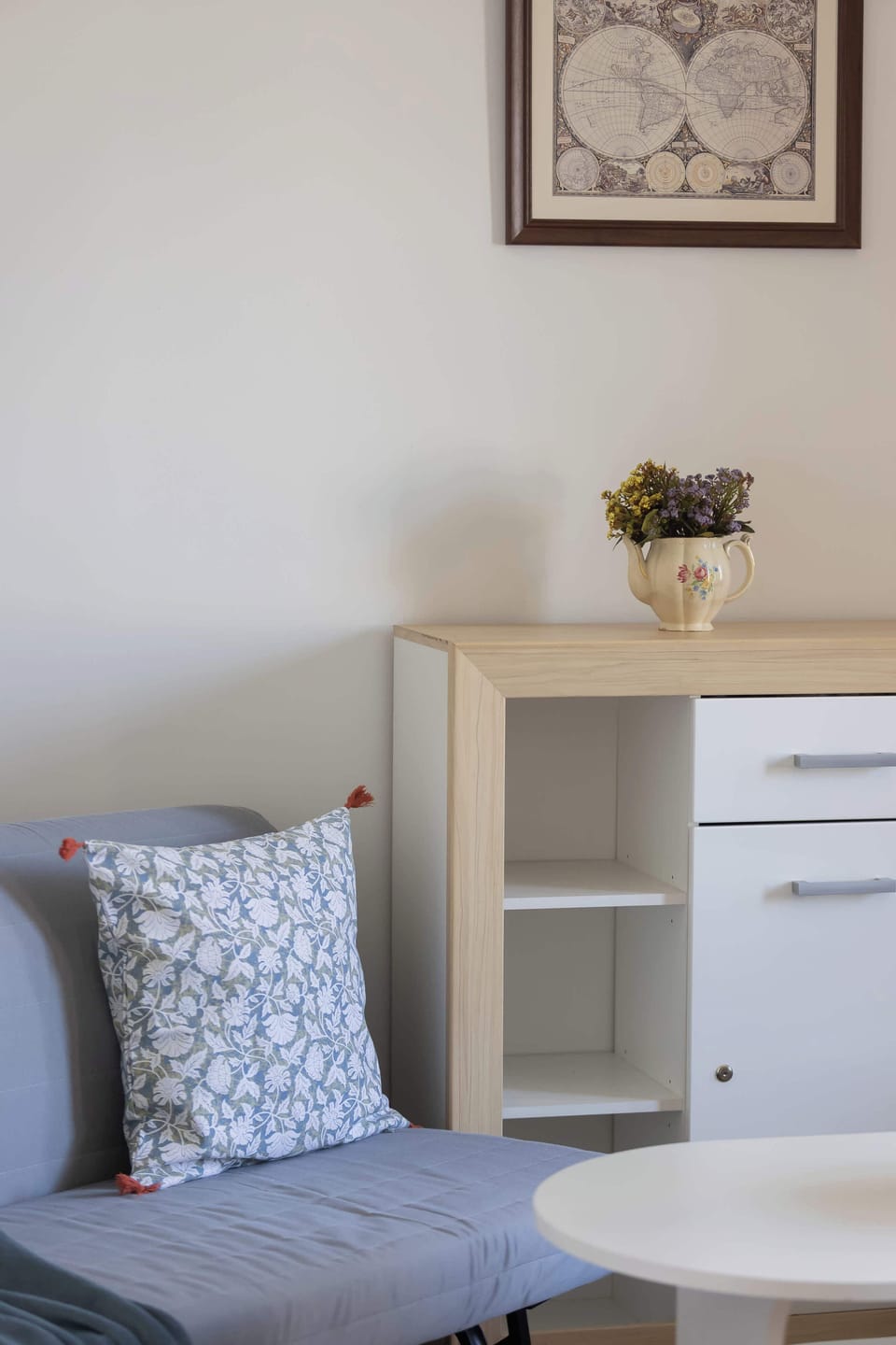 Cozy corner of the second bedroom with a sofa bed and side table.