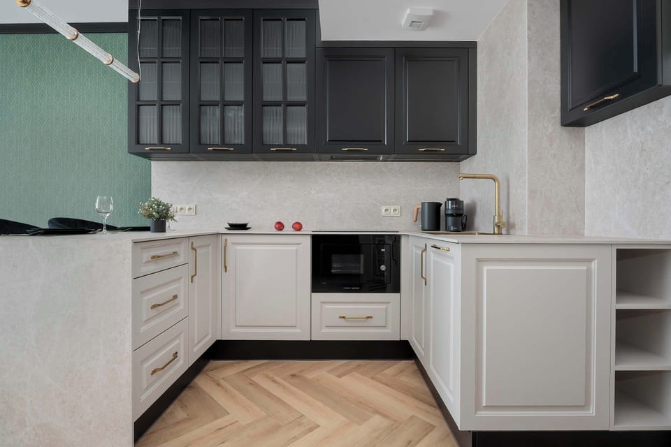 The kitchen workspace is shown from a low angle, emphasizing clean lines and integrated appliances. The wood flooring extends throughout.