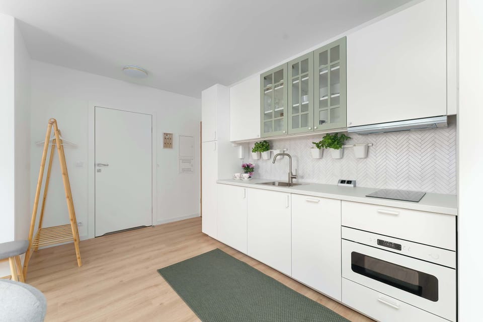 The sleek design of the kitchenette blending seamlessly with the living area.