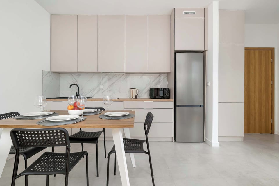 The sleek design of the kitchenette blending seamlessly with the living area.