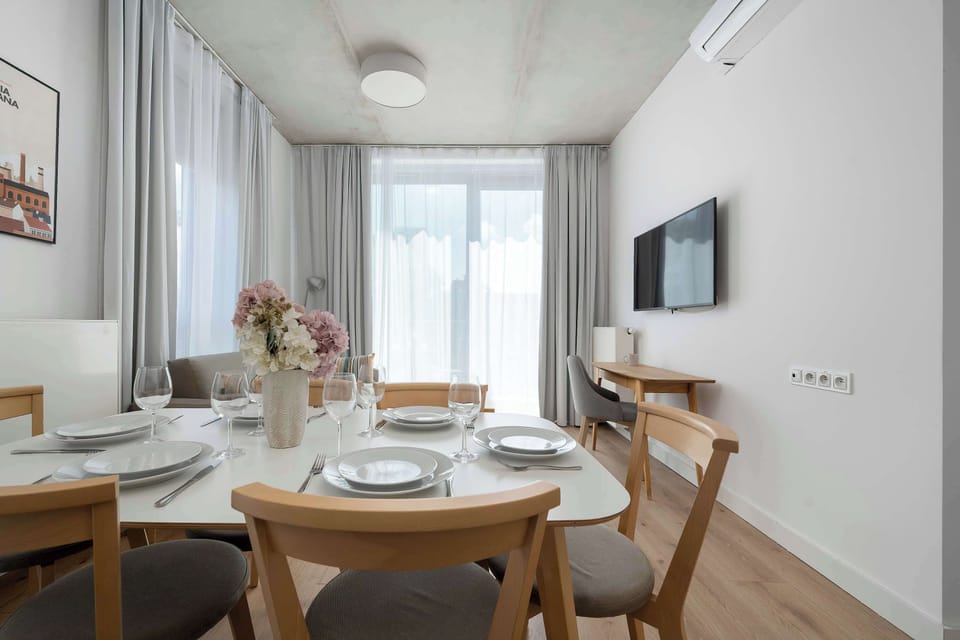 The elegant living room featuring a double sofa bed, perfect for relaxing or sleeping.