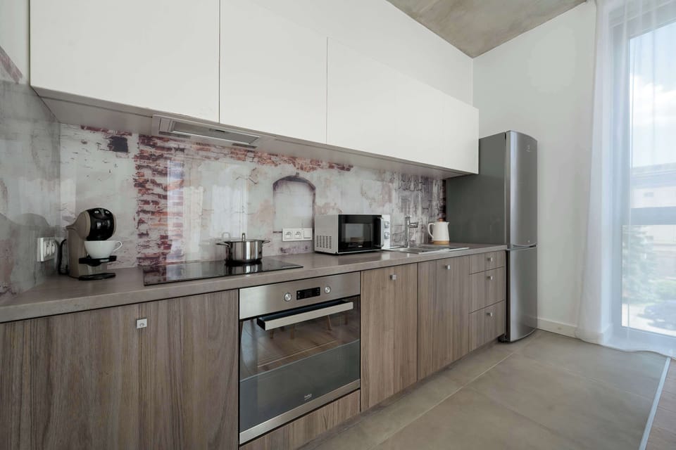 The sleek design of the kitchenette blending seamlessly with the living area.