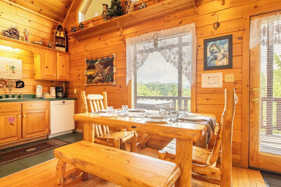 Gather around this rustic log dining table where mountain views greet you through large windows. The warm pine walls and cozy cabin charm create the perfect backdrop for your memorable meals together.