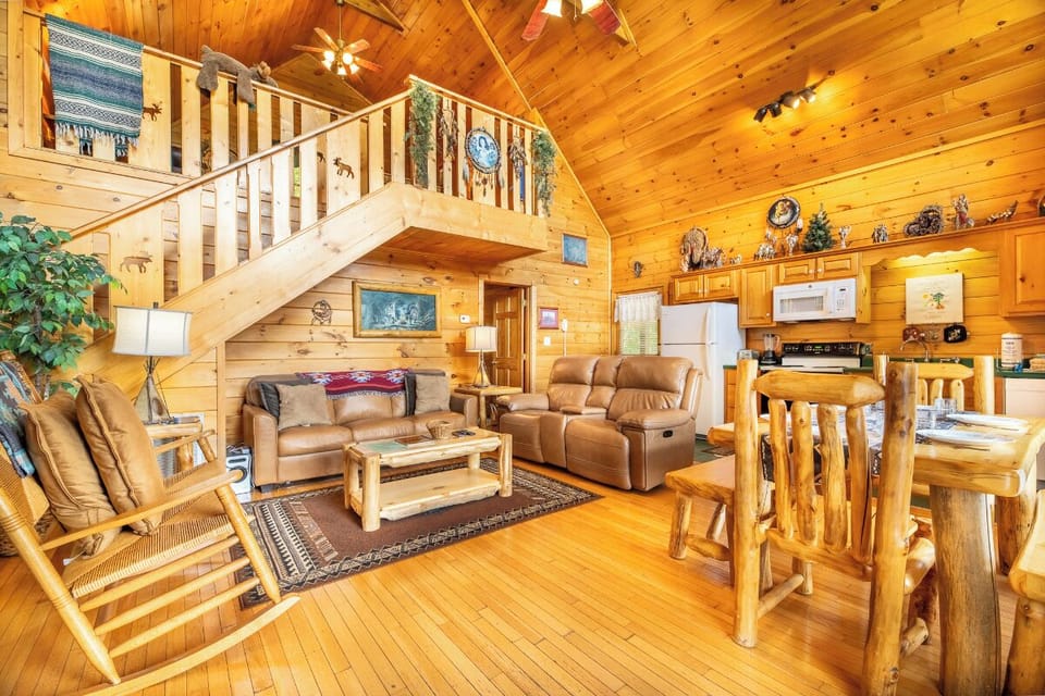 Step into your inviting cabin retreat, where rustic charm and cozy comfort blend seamlessly. Warm wood surrounds you, with a spacious loft above, a welcoming living area, and a fully-equipped kitchen—all designed to make you feel at home.