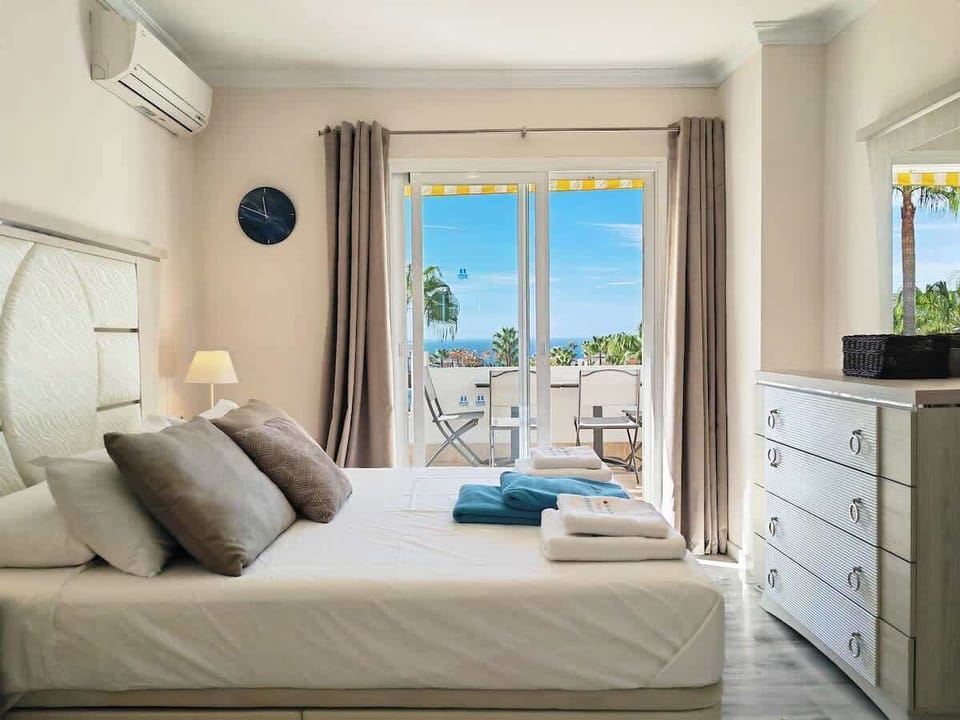 Primary room with patio and ocean, pool & garden view.