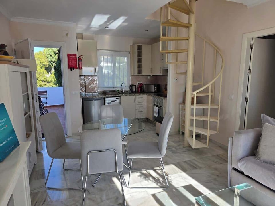 Open concept connecting kitchen with livingroom with smart tv & fireplace and upstairs bedroom plus bathroom.