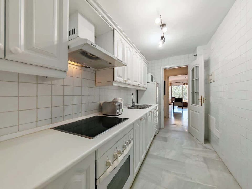 Kichen with microwave, oven and connected to laundry area
