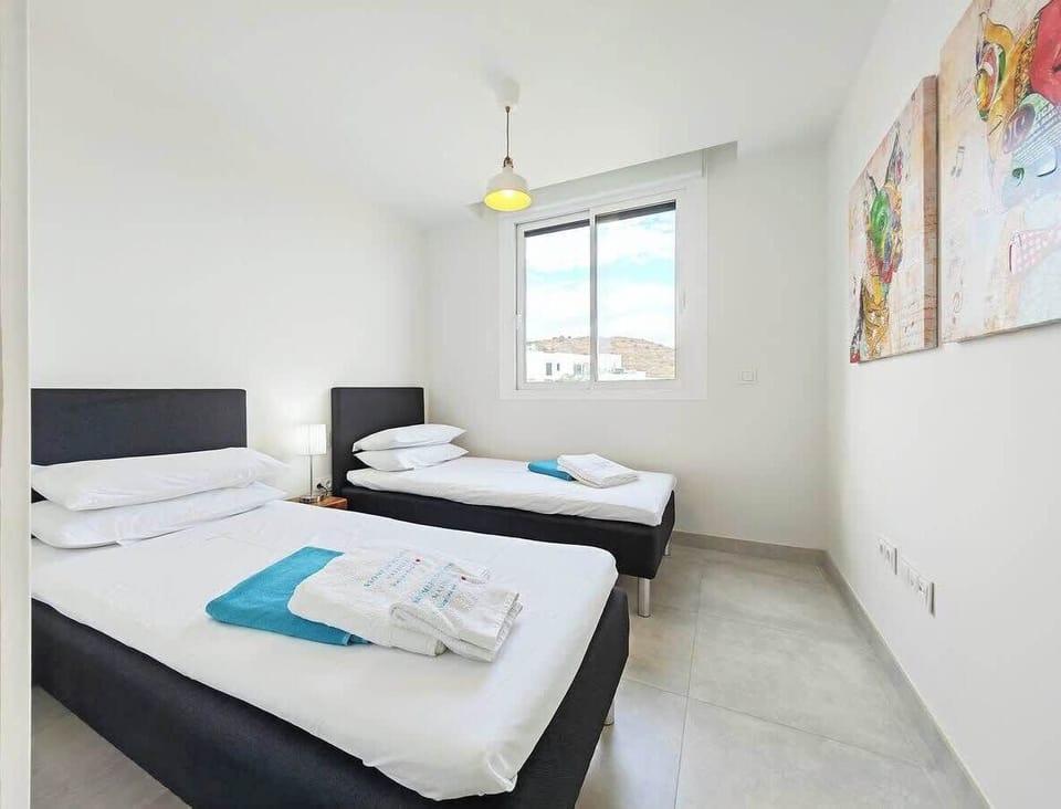 Guest room with view to community pool and mountain.