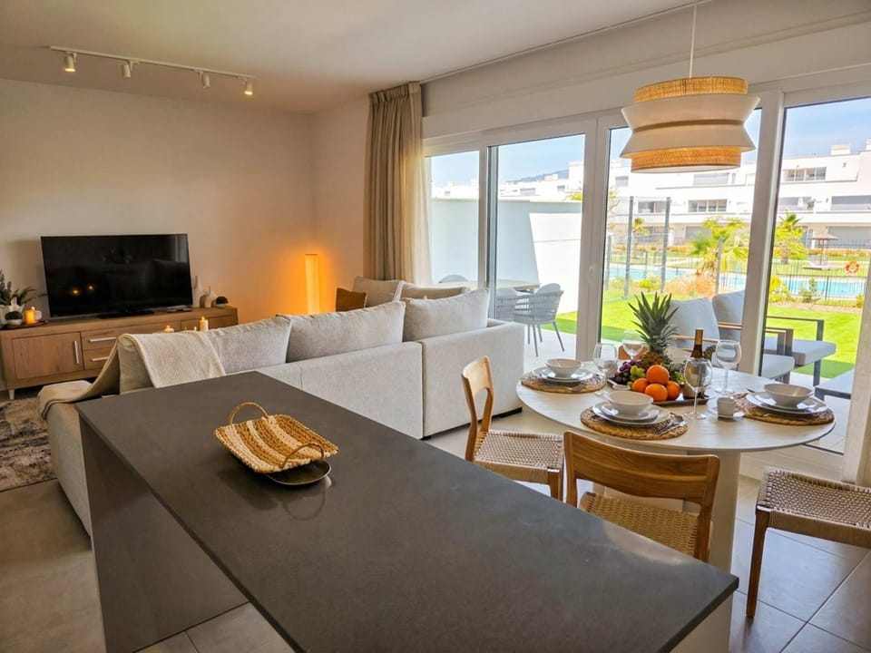 open kitchen livingroom & dinning area concept with view to garden and pool.