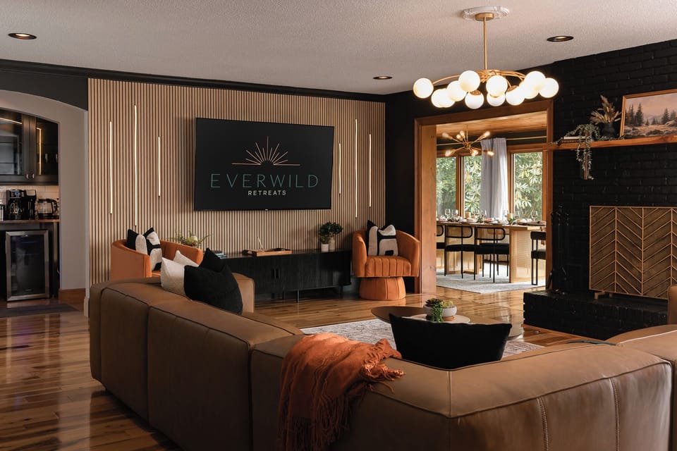 {Living Room} An open-concept gathering space connects the living room and kitchen so the whole group can relax, cook, and spend time together.
