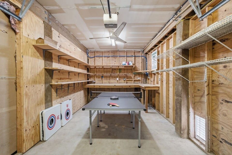 Enjoy this game room with ping pong & cornhole