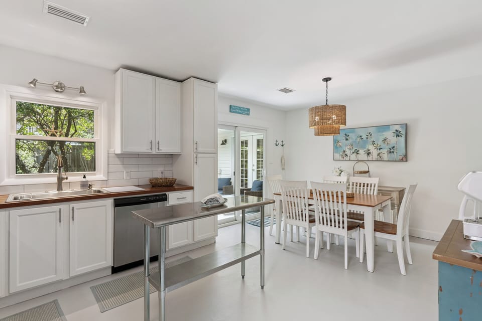 Your bright, open kitchen welcomes you with white cabinetry, warm wood countertops, and a charming dining nook—perfect for morning coffee or gathering with loved ones.