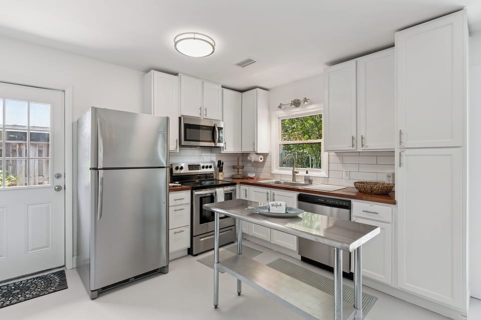 Cook your favorite meals in this bright, fully equipped kitchen, complete with stainless appliances, ample counter space, and a handy center island for easy meal prep.