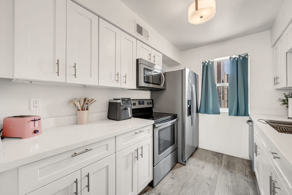 Fully equipped kitchen with generous cabinet and counter space.