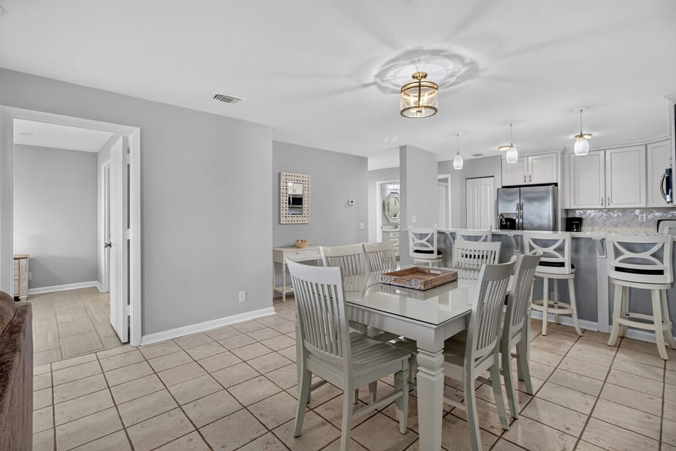Step into a bright, inviting open space where mealtimes feel effortless. Your dining area flows seamlessly into a modern kitchen, perfect for gathering with loved ones over home-cooked meals.