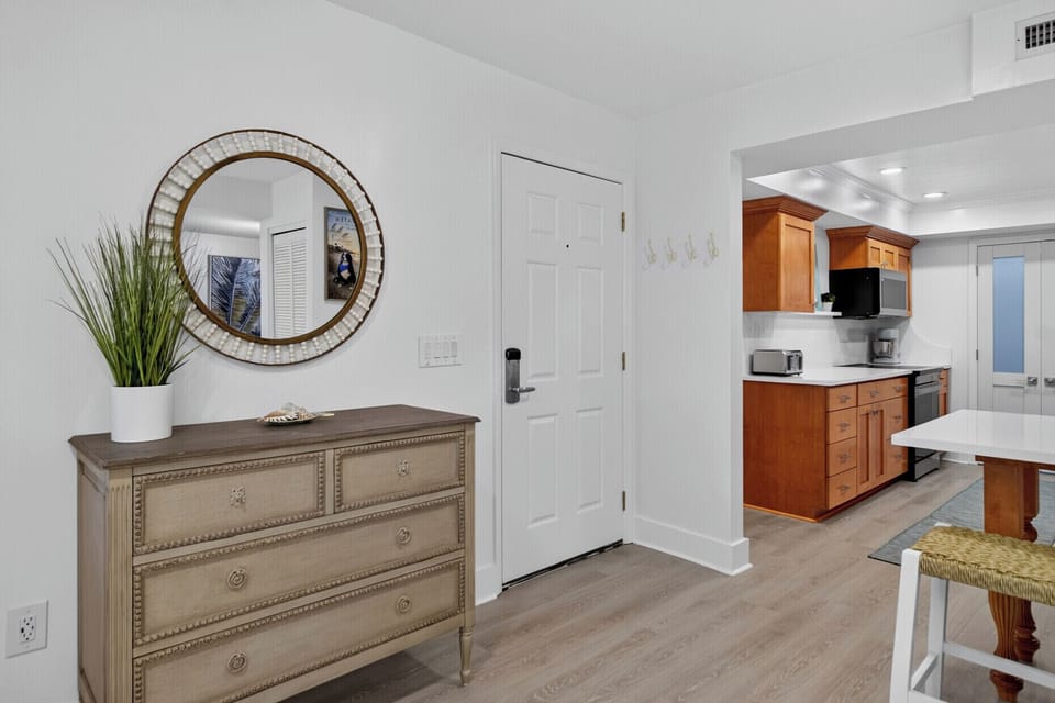 Step into your bright, open living space with coastal touches and a fully equipped kitchen ready for your stay.