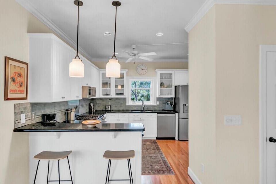 Your fully equipped kitchen invites you to whip up favorite meals with sleek countertops, modern appliances, and a cozy breakfast bar for morning coffee together.