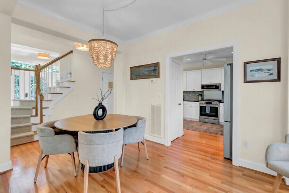 You'll love gathering around this elegant dining table, where warm wood tones meet soft seating under a stunning chandelier. Just steps away, your fully equipped kitchen awaits, ready for cozy meals at home.