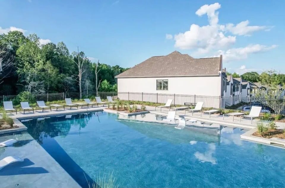 Resort-style pool with loungers and a relaxing in-water sun shelf