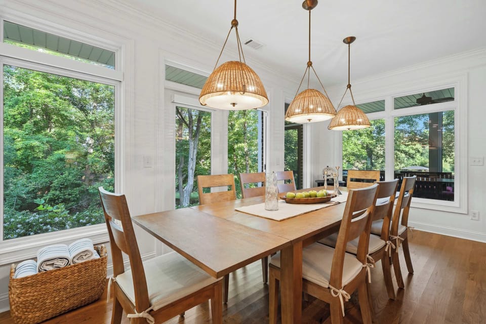 Surrounded by greenery on all sides — the dining area is bathed in natural light and treetop views, making every meal feel like an occasion.