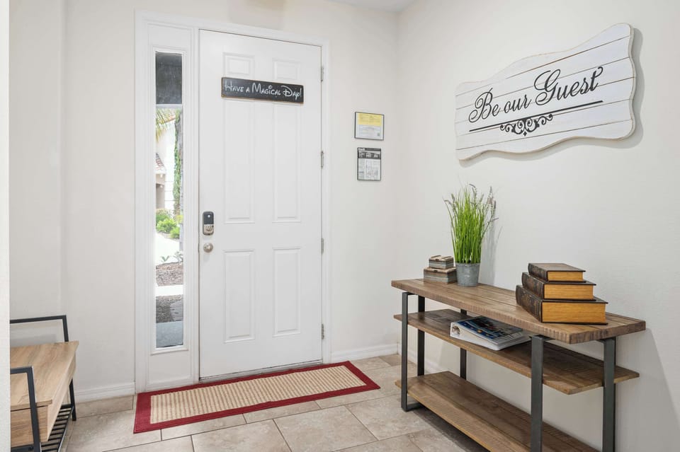 Entryway with a rustic console table and welcoming wall decor for guests.
