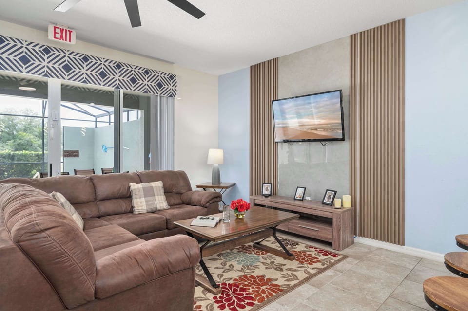 Cozy living room with a sectional sofa and wall-mounted television.