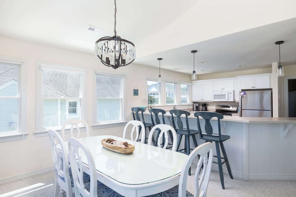 Dining Area with Ample Seating, Expansive Windows, and an Open-Concept Layout that Connects Effortlessly to the Kitchen and Living Room