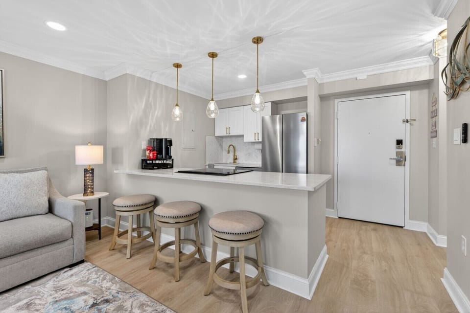 Gather around the breakfast bar for morning coffee, casual meals, or planning your next beach adventure.