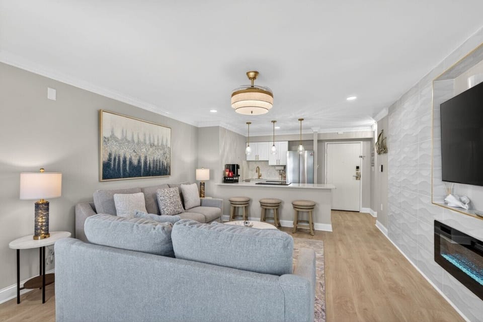 Gather, relax, and unwind in the bright open-concept living space featuring comfortable seating and a fully equipped kitchen.