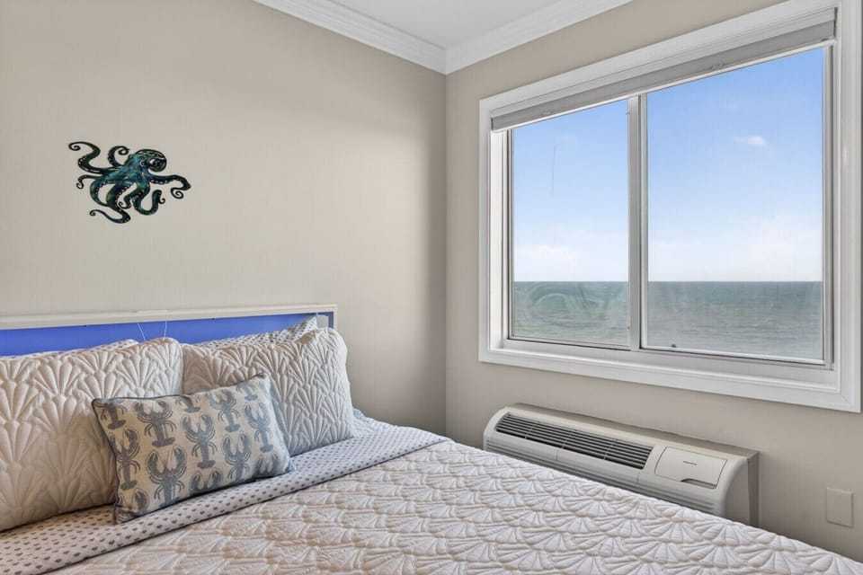 Drift off to the sound of the waves in this cozy coastal bedroom, complete with a plush queen bed and stunning ocean views right from your window.