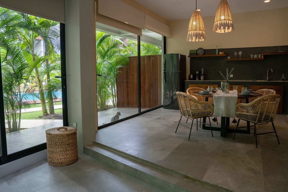 Enjoy indoor-outdoor dining with views of the tropical garden