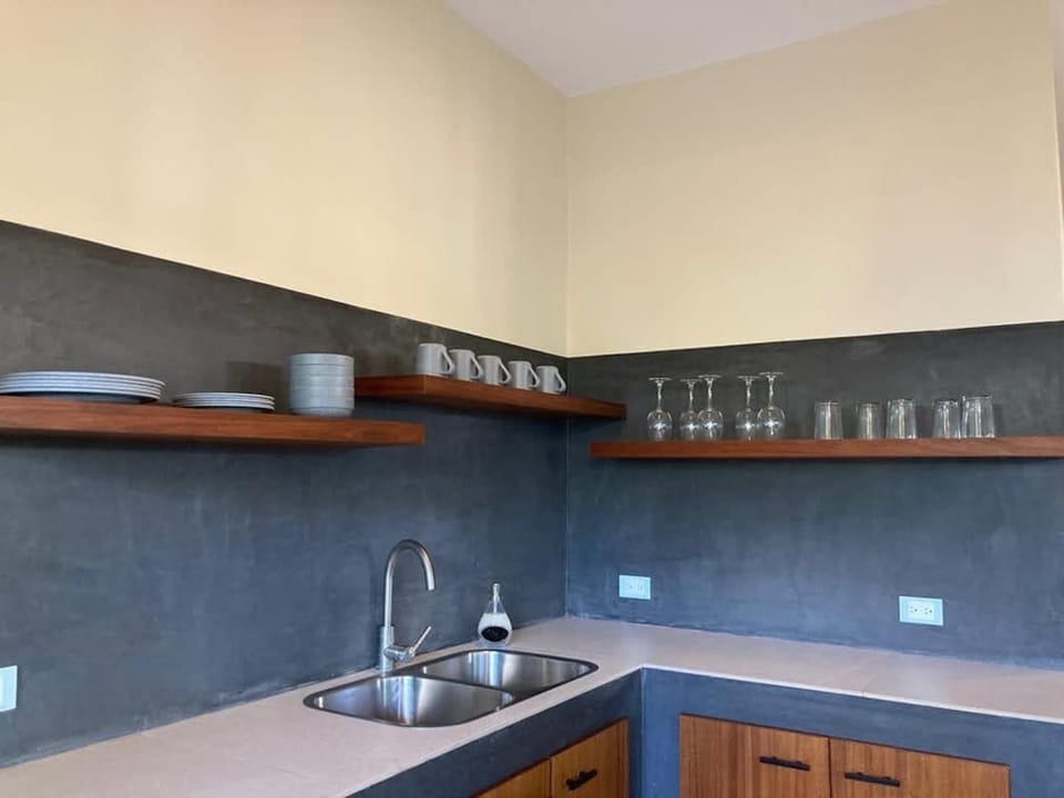 Prepare simple meals in a practical kitchen with open shelving
