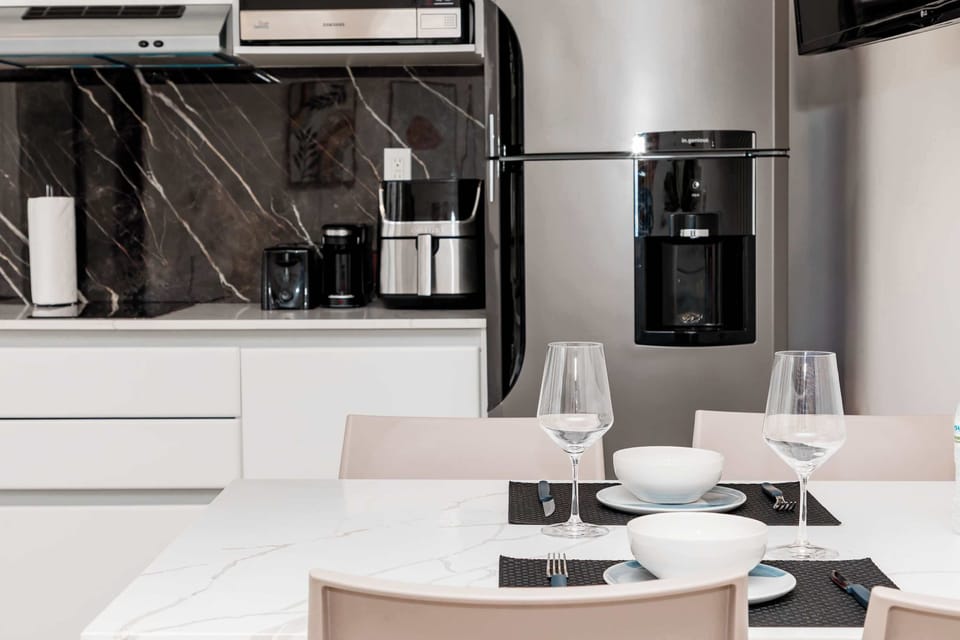 Functional kitchen and dining area with a full-size fridge, coffee maker, air fryer, and everything you need for simple meals during your stay.