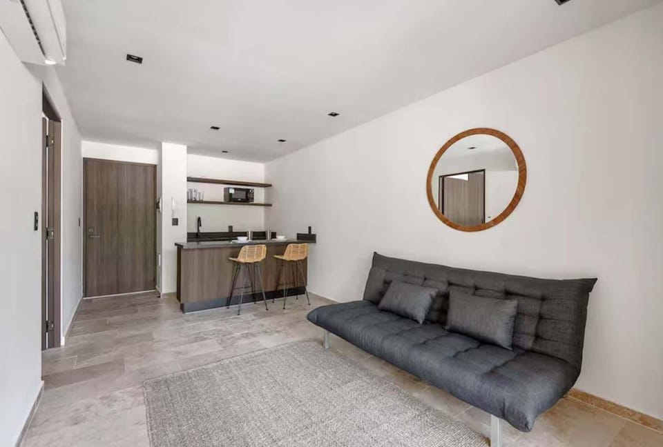 Elegant and cozy living room. A separate, bright space designed with local wood textures and organic materials to relax after a day at the beach.