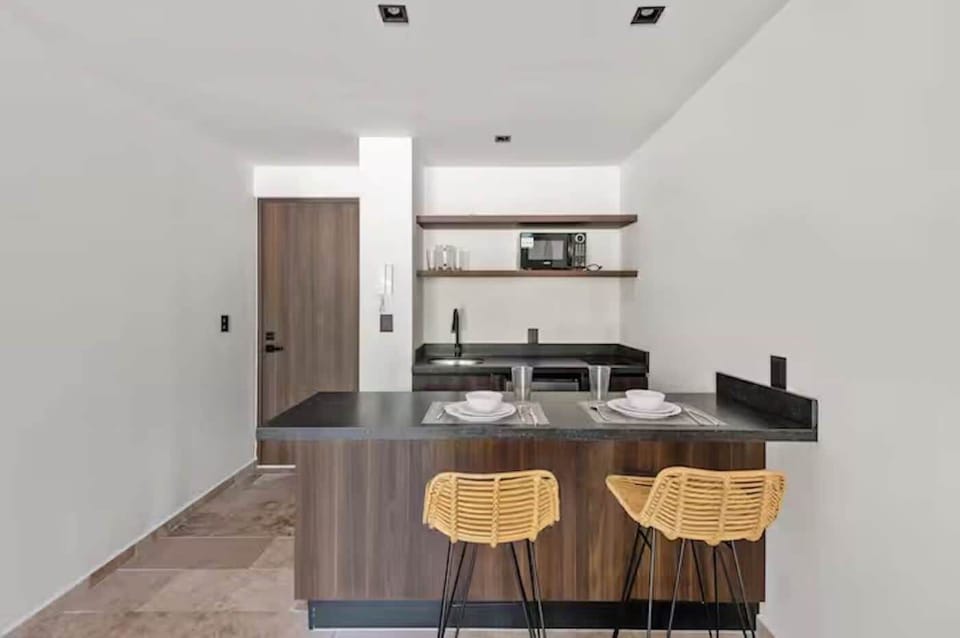 Morning coffee spot. A beautifully crafted breakfast bar with local wooden accents and stylish seating for two, perfect for remote work.