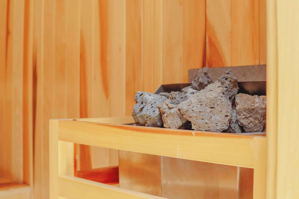 Your personal spa experience. Unwind in our rustic wood dry sauna with porous volcanic heating rocks, or step into the deep orange Chukum-walled steam room (Vapor) for a cleansing detox. A seamless blend of nature and comfort for your well-being.
