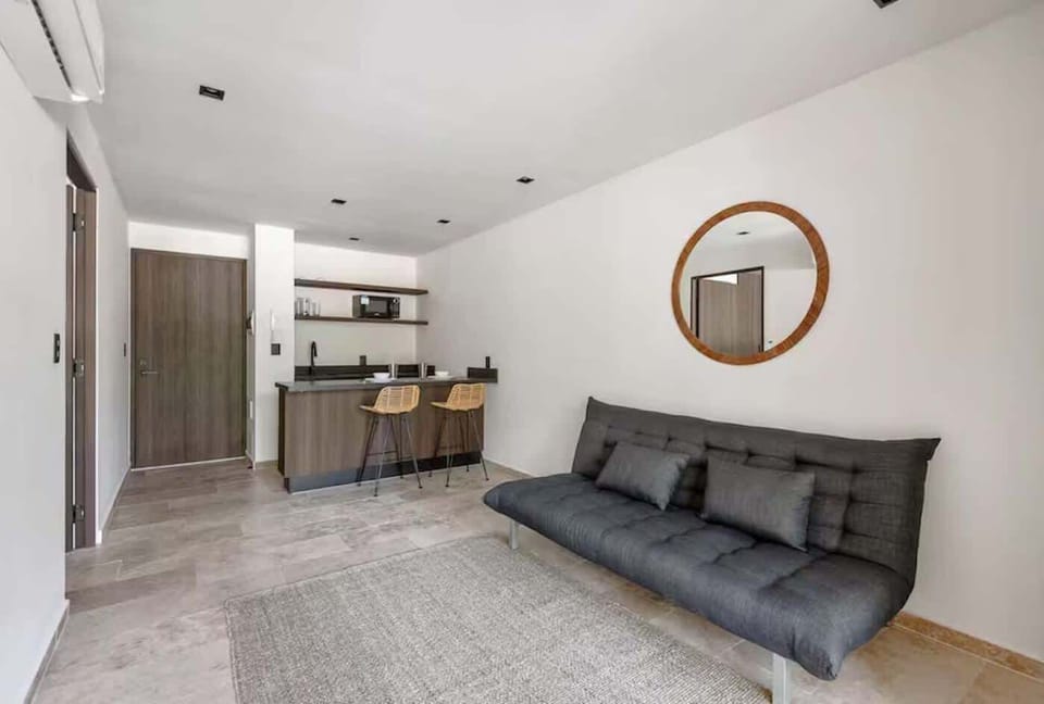 Elegant and cozy living room. A separate, bright space designed with local wood textures and organic materials to relax after a day at the beach.